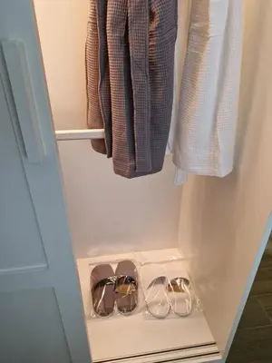 a closet with three pairs of shoes in it at Beachside Lagoon Bang Tao Laguna by OK group in Ban Thalat Choeng Thale