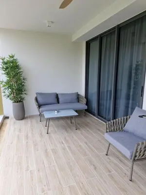 a living room with two couches and a table at Beachside Lagoon Bang Tao Laguna by OK group in Ban Thalat Choeng Thale
