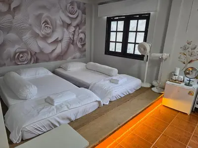 two beds in a room with a mural of flowers at THE REAL ESCAPE - Koh Yao Noi in Ko Yao Noi