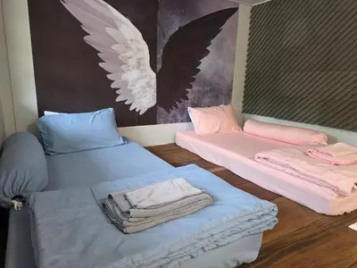 two beds in a room with wings on the wall at THE REAL ESCAPE - Koh Yao Noi in Ko Yao Noi