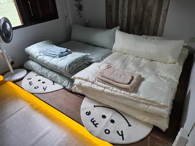 a living room with two beds and two rugs at THE REAL ESCAPE - Koh Yao Noi in Ko Yao Noi