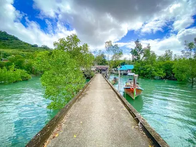a boat is docked at a dock on a river at THE REAL ESCAPE - Koh Yao Noi in Ko Yao Noi