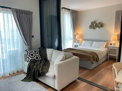 a bedroom with a bed and a couch and a chair at Coco Calm Title Halo 1 in Koh Lone