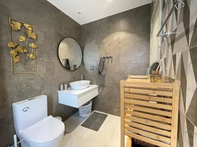 a bathroom with a toilet and a sink and a mirror at Coco Calm Title Halo 1 in Koh Lone