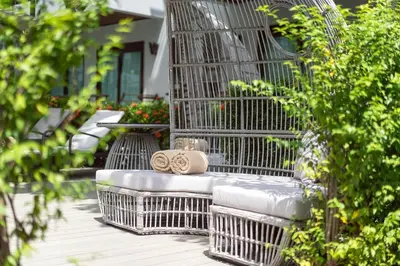 a metal bench with two napkins on top of it at Howard Johnson by Wyndham Phuket Naiyang in Thalang