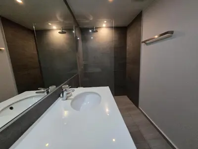 a bathroom with a tub and a white sink at Easy Stay – 2-Bedroom T2-618 in Phuket Town