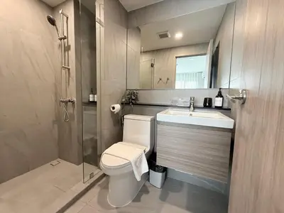 a bathroom with a toilet and a sink and a shower at New Stylish Cozy One-bedroom Apartment in Bangtao, Phuket, Near EDC in Ban Thalat Choeng Thale