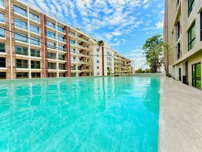 an empty swimming pool in front of a building at New Stylish Cozy One-bedroom Apartment in Bangtao, Phuket, Near EDC in Ban Thalat Choeng Thale