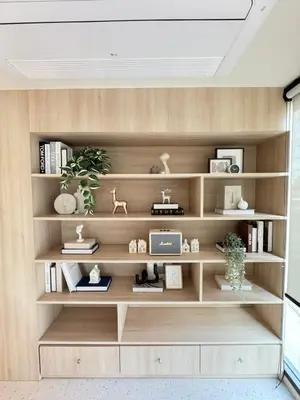 a room with wooden shelves with books at New Stylish Cozy One-bedroom Apartment in Bangtao, Phuket, Near EDC in Ban Thalat Choeng Thale