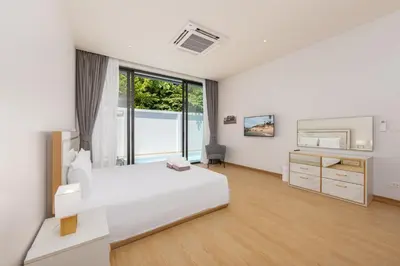a white bedroom with a bed and a dresser at Villa Noa Modern 2-Bedroom with Private Pool in Rawai Beach