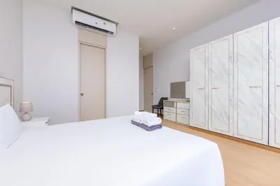 a white bedroom with two beds and a desk at Villa Noa Modern 2-Bedroom with Private Pool in Rawai Beach
