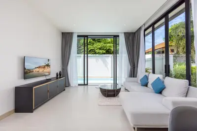 a living room with a couch and a tv at Villa Noa Modern 2-Bedroom with Private Pool in Rawai Beach