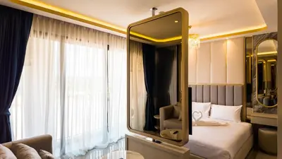 a bedroom with a large mirror and a bed at Apartment studio in Bellevue Lagoon on Bang Tao in Laguna Phuket