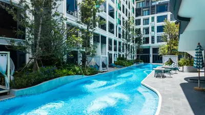 a swimming pool in front of a building at Apartment studio in Bellevue Lagoon on Bang Tao in Laguna Phuket