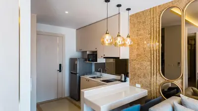 a kitchen with a couch and a sink in a room at Apartment studio in Bellevue Lagoon on Bang Tao in Laguna Phuket