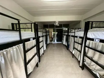 a row of bunk beds in a room at Klong Muang Hostel คลองม่วงโฮสเทล in Ban Ko Kwang