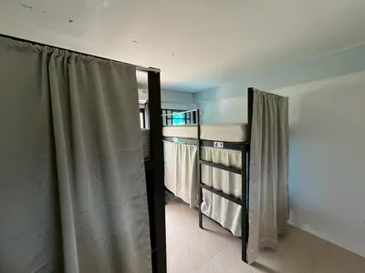 a room with a shower curtain in a room at Klong Muang Hostel คลองม่วงโฮสเทล in Ban Ko Kwang