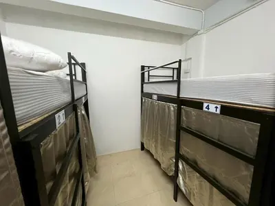 two bunk beds in a small room with the number at Klong Muang Hostel คลองม่วงโฮสเทล in Ban Ko Kwang