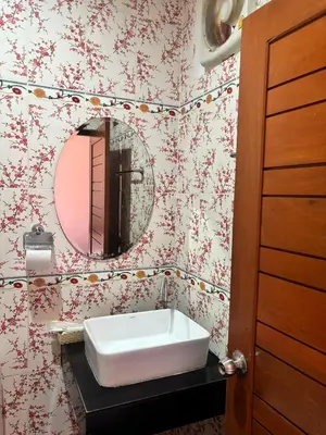 a bathroom with a sink and a mirror at Saiinam Laguna Inn in Ban Thalat Choeng Thale