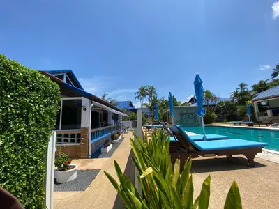 a resort with a swimming pool with a lounge chair at Villa Jasmine in Rawai Beach