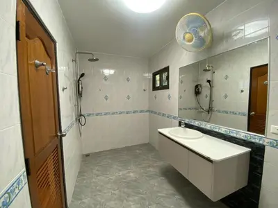 a bathroom with a sink and a toilet and a mirror at Villa Jasmine in Rawai Beach