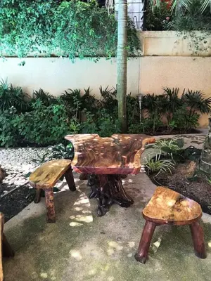 a wooden bench and a table and two benches at One-bedroom condo on Nai Harn Beach, Rawai in Rawai Beach