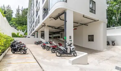 a row of motorcycles parked outside of a building at Fantasea by Villacarte in Kamala Beach