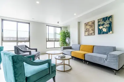 a living room with couches and chairs at Fantasea by Villacarte in Kamala Beach
