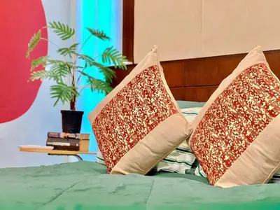two pillows sitting on top of a bed at MYSA House Pool Villa Central Phuket in Phuket
