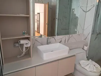 a bathroom with a sink and a mirror and a toilet at Kamala falls seaview 1 bedroom in Phuket Town