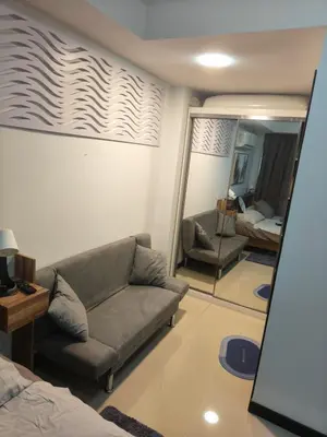 a living room with a couch and a mirror at Lux apartment Mai Khao beach in Mai Khao Beach