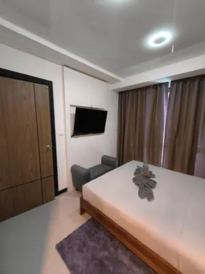 a hotel room with a bed and a television at Lux apartment Mai Khao beach in Mai Khao Beach