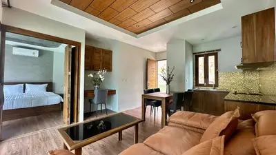 a living room with a couch and a bedroom at Villa avec piscine privée in Kamala Beach