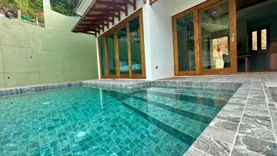 a swimming pool in the middle of a house at Villa avec piscine privée in Kamala Beach