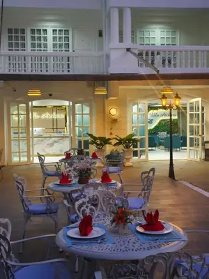 a room with tables and chairs in a building at Villa Atchara in Patong Beach