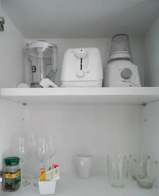 a shelf with glasses and a blender on it at 1 bedroom Mida Grande Resort, Phuket in Surin Beach