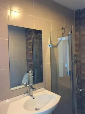 a bathroom with a sink and a shower with a mirror at XX GO Inn Krabi Aonang Beach - โกอินน์ อ่าวนาง in Ban Khlong Haeng