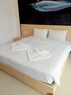 a bed with white towels on top of it at XX GO INN Aonang Beach - หาดอ่าวนาง กระบี่ in Ban Khlong Haeng