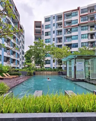 a swimming pool in front of some buildings at cen 1 bed room862 in Ban Rangeng
