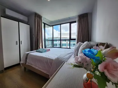 a bedroom with a bed and a table with a vase of flowers at cen 1 bed room862 in Ban Rangeng