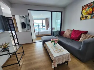 a living room with a couch and a table at cen 1 bed room862 in Ban Rangeng