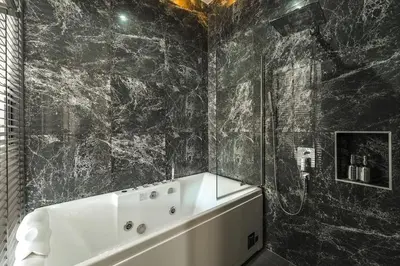 a bathroom with a white tub and black marble walls at V162 Super Modern Brand New Stunning Design in Rawai Beach