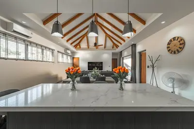 a living room with a large white table with vases of oranges at V162 Super Modern Brand New Stunning Design in Rawai Beach