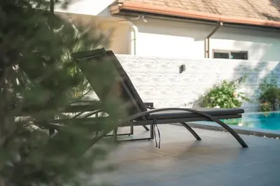 a chair sitting on a patio next to a pool at V162 Super Modern Brand New Stunning Design in Rawai Beach