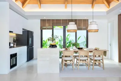 a kitchen with a dining room table with chairs at Lerka Villa Elegant 3 Bedroom in Rawai Beach