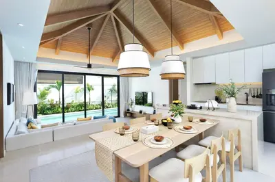 a kitchen and living room with a table and chairs at Lerka Villa Elegant 3 Bedroom in Rawai Beach