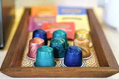 a wooden tray filled with different colored dominoes at Lerka Villa Elegant 3 Bedroom in Rawai Beach