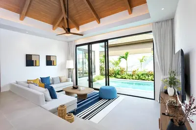 a living room with a white couch and a tv at Lerka Villa Elegant 3 Bedroom in Rawai Beach