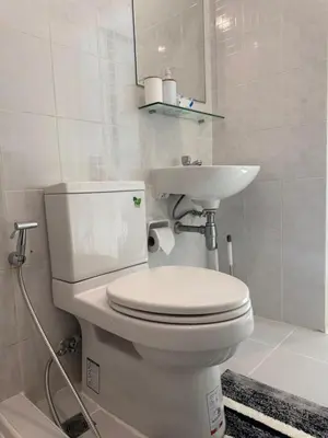 a white bathroom with a toilet and a sink at Zcape 1 Condo Cherngtalay Thalang Gym pool Wifi Netflix Walk to All in Ban Thalat Choeng Thale