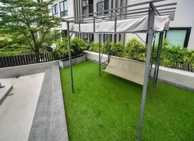 a batting cage in front of a building with green grass at Zcape 1 Condo Cherngtalay Thalang Gym pool Wifi Netflix Walk to All in Ban Thalat Choeng Thale